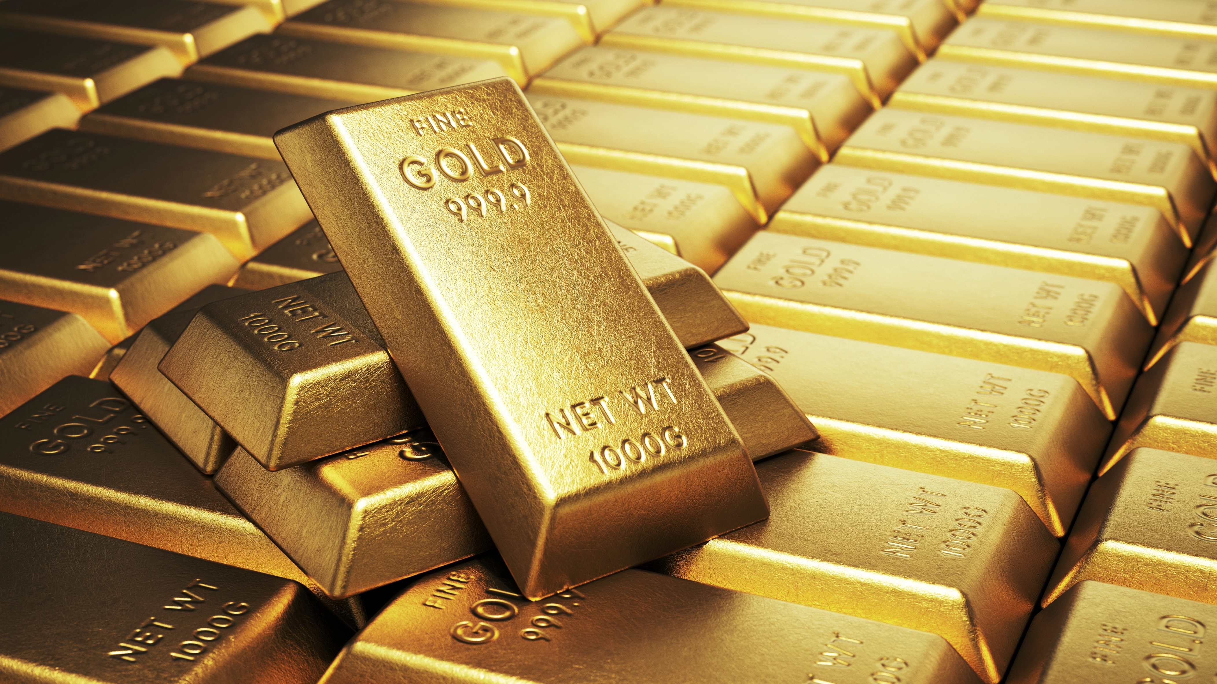 Gold and silver bullion bars stacked