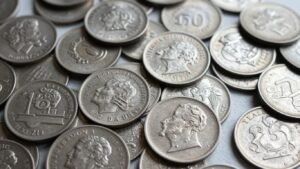 Pile of old silver coins with visible details.